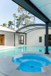a swimming pool in a house with a building at Camping Le California in Saint-Jean-de-Monts +20 photos