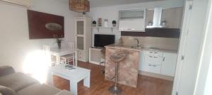 a small kitchen and living room with a couch at El Refugio 2 Pax - WIFI in Tarifa