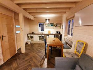 a kitchen and dining room with a table in a tiny house at Blue Lake House in Lekarty