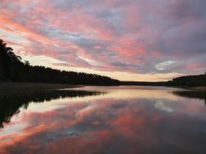 a view of a lake with a cloudy sky at Blue Lake House in Lekarty +4 photos