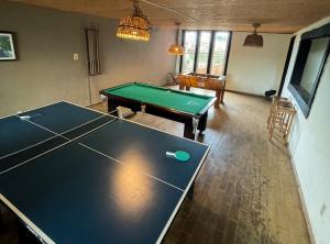 a living room with a ping pong table in it at Pousada Província in Lavras Novas