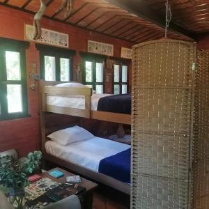 a room with two bunk beds in a house at La Estancia hostel in Colonia del Sacramento