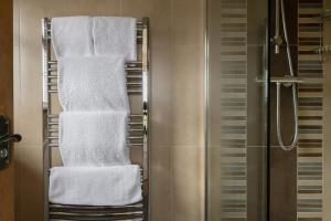 a bunch of towels on a towel rack in a bathroom at The Country Lodge at Hill House Farm Cheshire in Tarporley +24 photos
