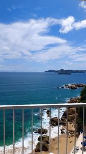 a view of the ocean from a balcony at Suite Claus in Acapulco