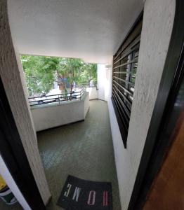a hallway of a building with a window and a rug at Departamento en el centro de Mendoza in Mendoza