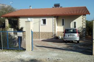a car parked in front of a house at Marry's Guesthouse in Kineta