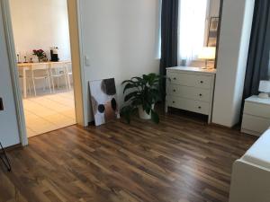 a living room with a hard wood floor and a plant at APT im Herzen von Mainz in Mainz