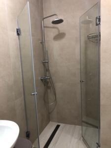 a shower with a glass door in a bathroom at Apartments Bane in Herceg-Novi