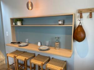 a table with stools and plates on a shelf at La Suite du Héron nantais in Nantes