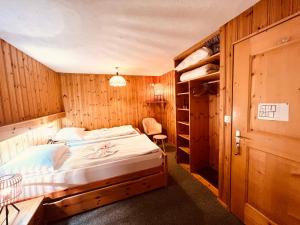 a bedroom with a bed in a wooden room at SKY Rooms, Mountainous View in Saas