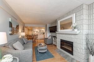 a living room with a couch and a fireplace at 105A Efficiency One Bath in Oakland