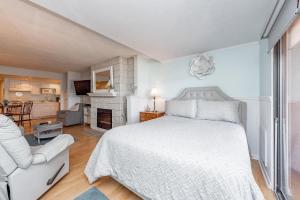 a bedroom with a white bed and a living room at 105A Efficiency One Bath in Oakland +17 photos
