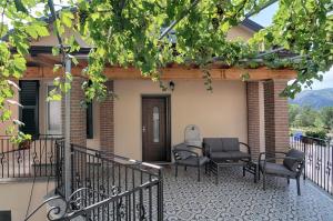 a patio with chairs and a table on a house at Hotel Da Bruno in Rocchetta Ligure