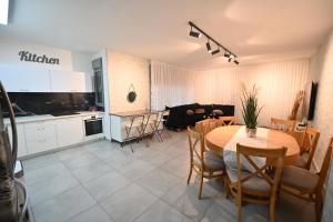 eine Küche und ein Esszimmer mit einem Tisch und Stühlen in der Unterkunft דירה luxury על הפארק חניה חינם in Migdal Afeq
