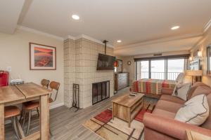 a living room with a couch and a fireplace at 203A Efficiency One Bath in Oakland