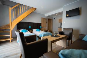 a hotel room with two beds and a staircase at Tramontana Family & Wellness in Darlowko