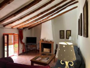 a living room with a couch and a fireplace at Cortijo EL COSIO in Benamaurel