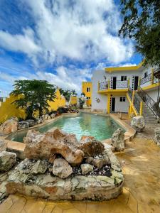 una piscina con rocas frente a una casa en Buenosdías Izamal, en Izamal