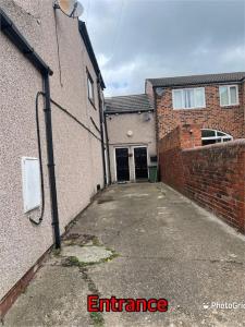 an empty alley with a building with a garage at Super deluxe extra large 3 bedroom apartment in Stanley