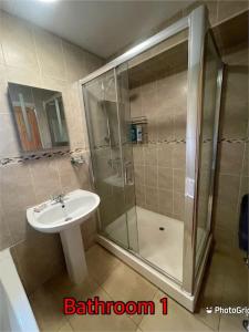 a bathroom with a sink and a shower at Super deluxe extra large 3 bedroom apartment in Stanley