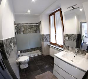 a bathroom with a toilet and a sink and a mirror at Hotel Da Bruno in Rocchetta Ligure