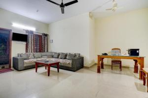 a living room with a couch and a table at Shalom Palace in Cochin
