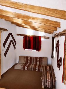 a room in a house with two beds in it at Wallpari Sonqo Hospedaje Medicina temazcal in Pisac