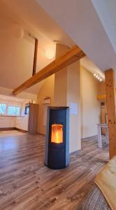 a fireplace in the middle of a living room at Ferienwohnung Sternenstube in Völkenroth