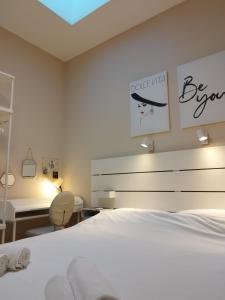 a bedroom with a bed and a desk and a chair at Apartment Vespa & Jacuzzi in Split