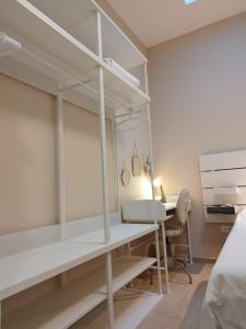 a bedroom with a bed and a desk and a bed and a room with at Apartment Vespa & Jacuzzi in Split