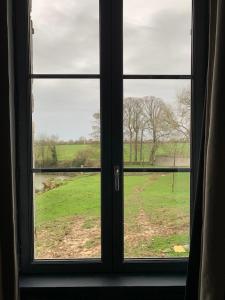 a window with a view of a field through it at CHÂTEAU DE FRANQUETOT & D Day Collins Museum in Sainte-Mère-Église +146 photos