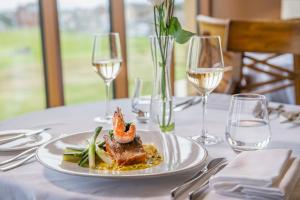a plate of food on a table with wine glasses at Old Course Hotel St Andrews in St. Andrews