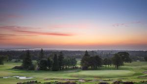 a view of a golf course at sunset at Old Course Hotel St Andrews in St. Andrews