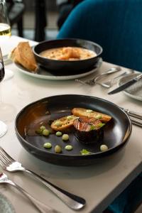 a table with two plates of food on a table at Old Course Hotel St Andrews in St. Andrews