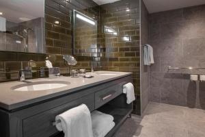 a bathroom with a sink and a large mirror at Old Course Hotel St Andrews in St. Andrews