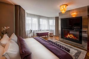 a living room with a fireplace and a bath tub at Old Course Hotel St Andrews in St. Andrews