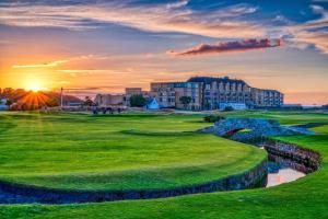 a view of a golf course at sunset at Old Course Hotel St Andrews in St. Andrews