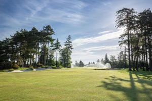 a water fountain in the middle of a golf course at Old Course Hotel St Andrews in St. Andrews