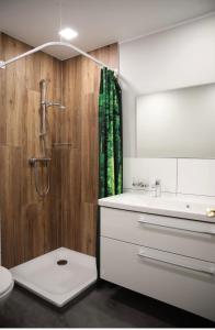 a bathroom with a shower and a toilet and a sink at Hotel Hof Kirchhorst in Groß Wittensee