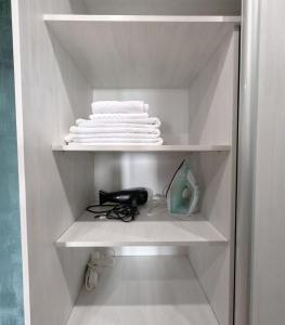 a white closet with white towels on a shelf at Слава Героям 11 Сеть апартаментов Alex Apartments Бесконтактное заселение 24-7 in Poltava