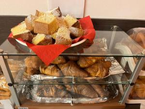 a display case filled with different types of pastries at Hotel Fiera in Bolzano