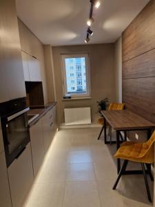 a kitchen and dining room with a table and a window at AMA by Melis in Braşov