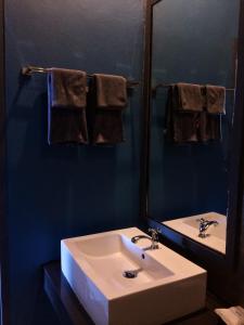 a bathroom with a sink and a mirror and towels at Wang Put Tan Boutique House in Mae Salong