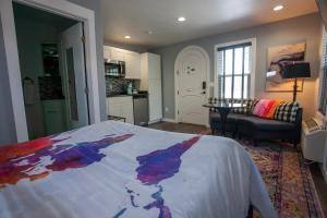 a bedroom with a bed with a painting on it at EO Bungalows, Black Hills in Custer