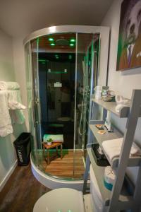 a bathroom with a shower with a glass door at EO Bungalows, Black Hills in Custer