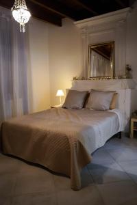 a bedroom with a large white bed with a mirror at Suite parentale de luxe in Rouffignac