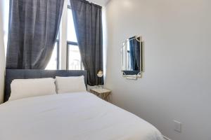 - une chambre avec un lit blanc et une fenêtre dans l'établissement M11 Gorgeous 3BR wKingBed Perfect Location, à Montréal