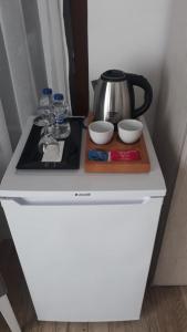 a counter with a coffee pot and bowls on it at Yakamoz Otel in Urla
