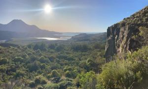 a view of a valley with a river and mountains at Refugio Casa Piedra in Puerto Ingeniero Ibáñez