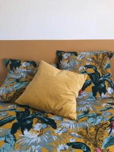 a bed with a pillow on top of it at Petite longère du Clos Madeleine in Vincelles
